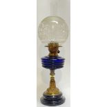 A brass and blue glass oil lamp with etched glass shade (total height- 60cm), together with a cast