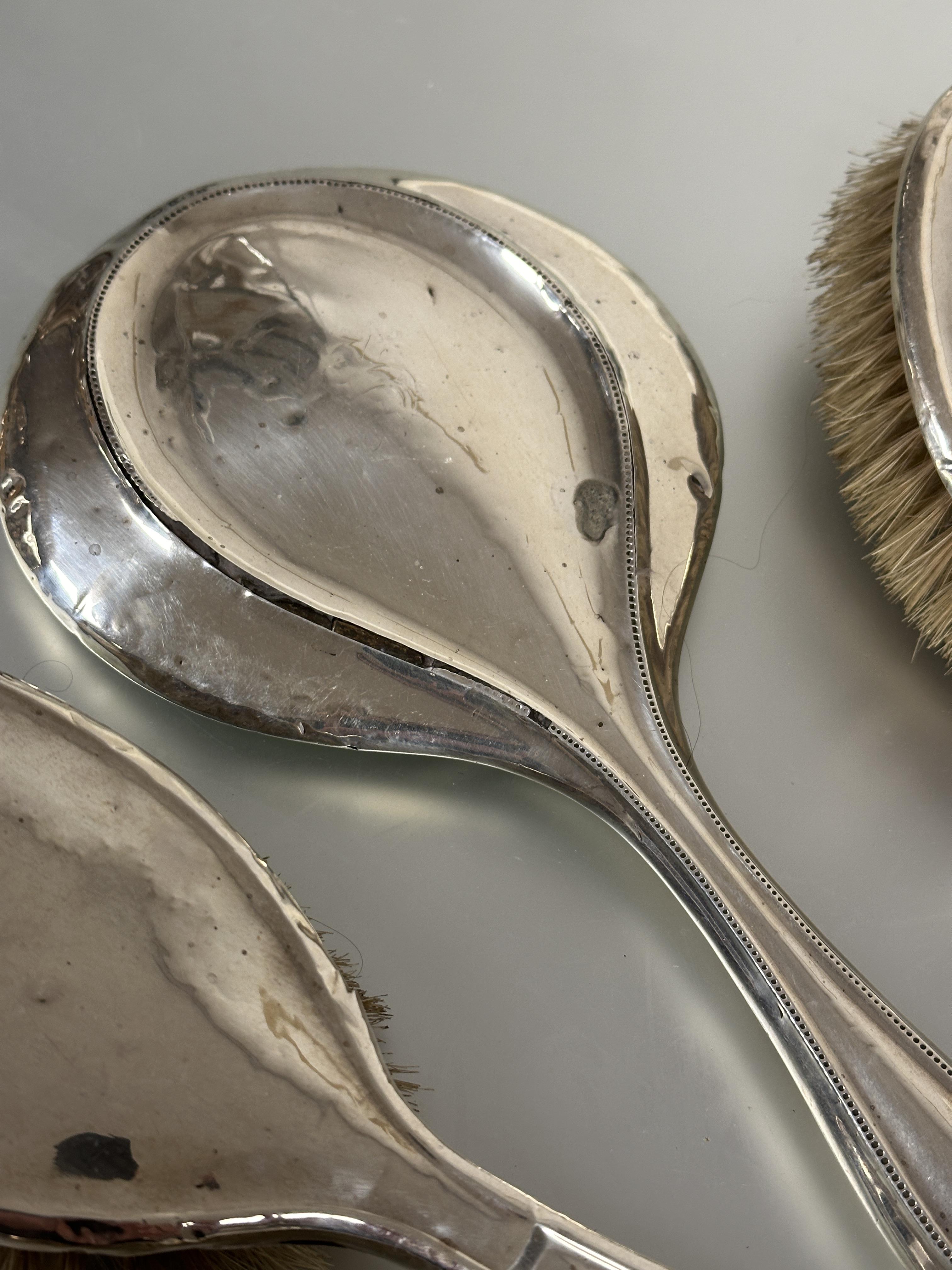 A Birmingham silver assembled dressing table set comprising a pair of oval hair brushes L x 24cm, - Image 3 of 4