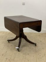 An Regency mahogany supper table, the top with brass string inlay, twin drop leaves and reeded