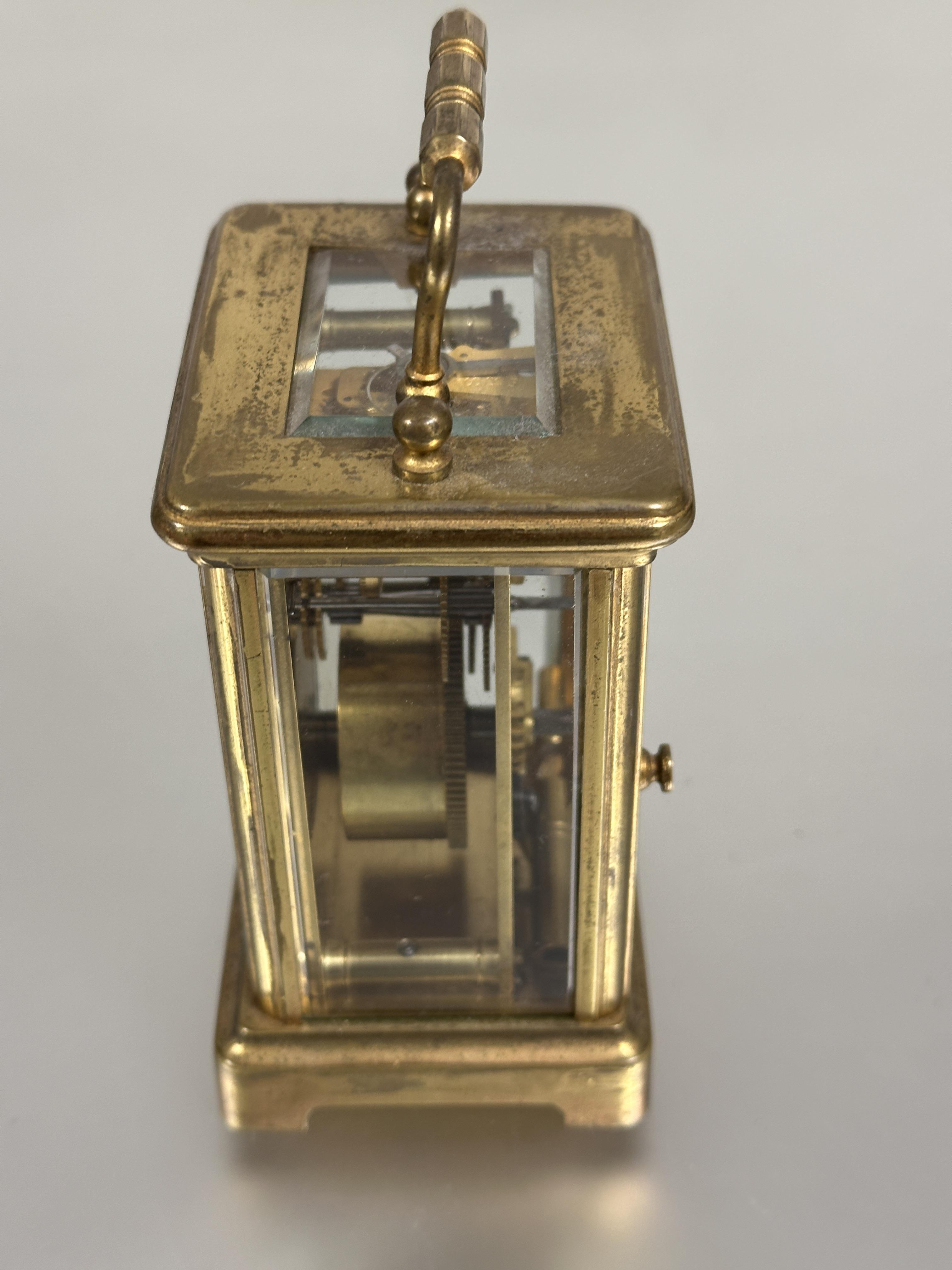 A modern brass four glass clock with folding carry handle to top white enamel dial with roman - Image 5 of 5