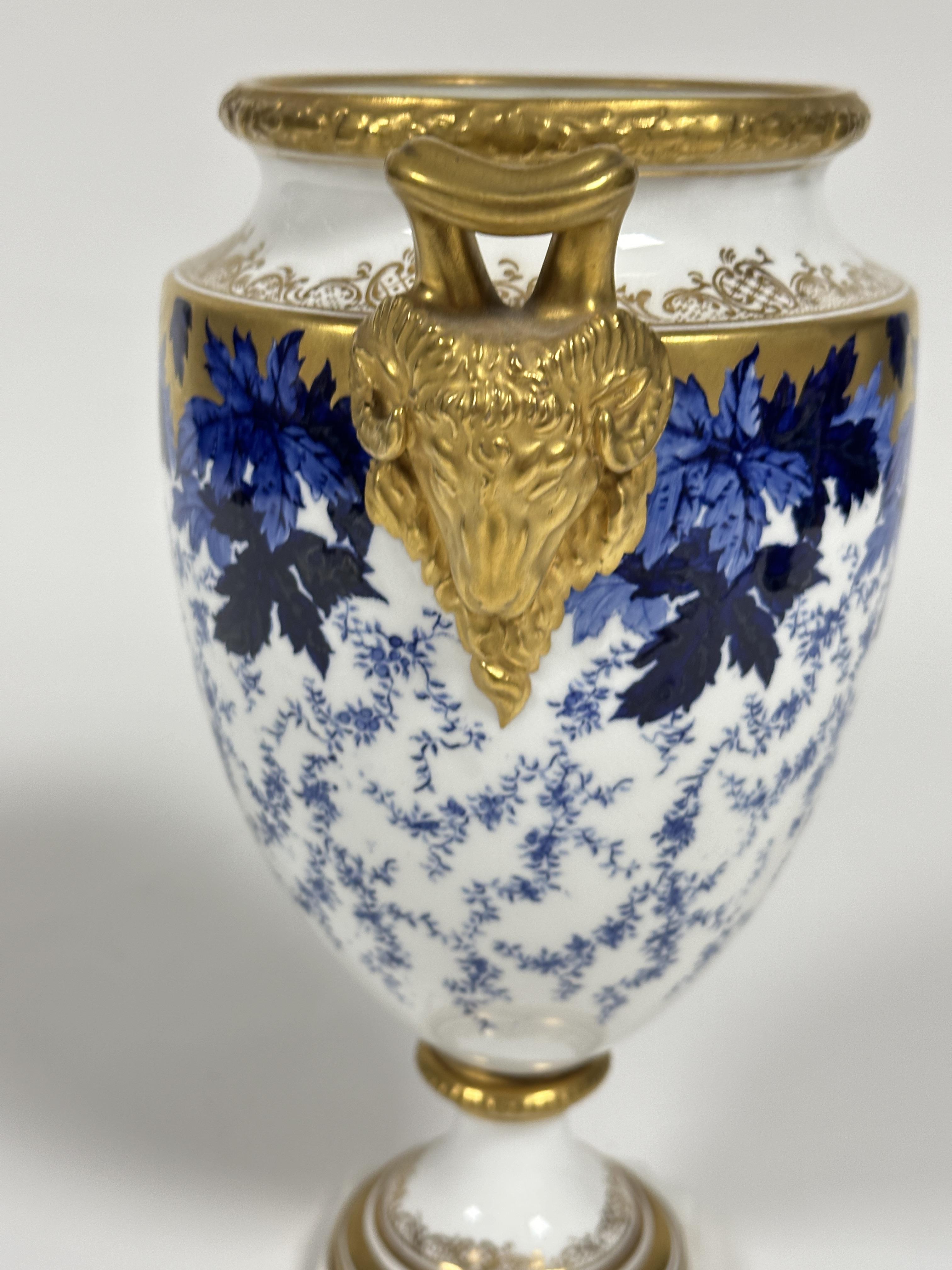 A early 20thc Coalport china two handled urn vase of tapered cylindrical form with twin gilt rams - Image 4 of 6
