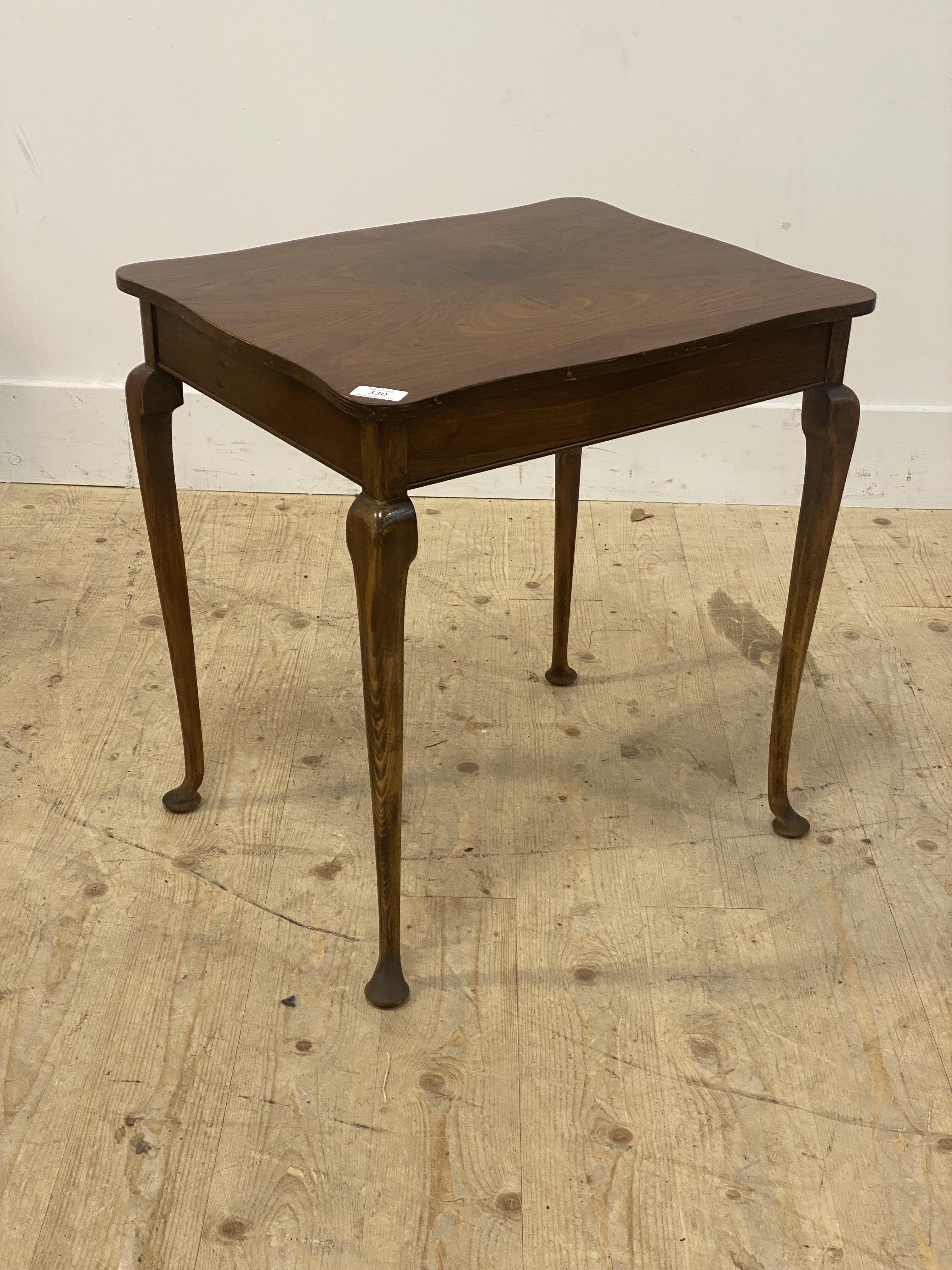 A walnut side table, the quarter sawn veneered top raised on cabriole supports. H54cm.