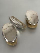 A set of three Edwardian Birmingham silver backed Gents hair and clothes brush with engraved with