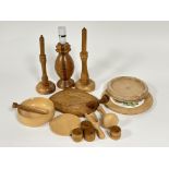 A collection of treen ware to include two pine turned wood candlesticks with wooden candles H x 30