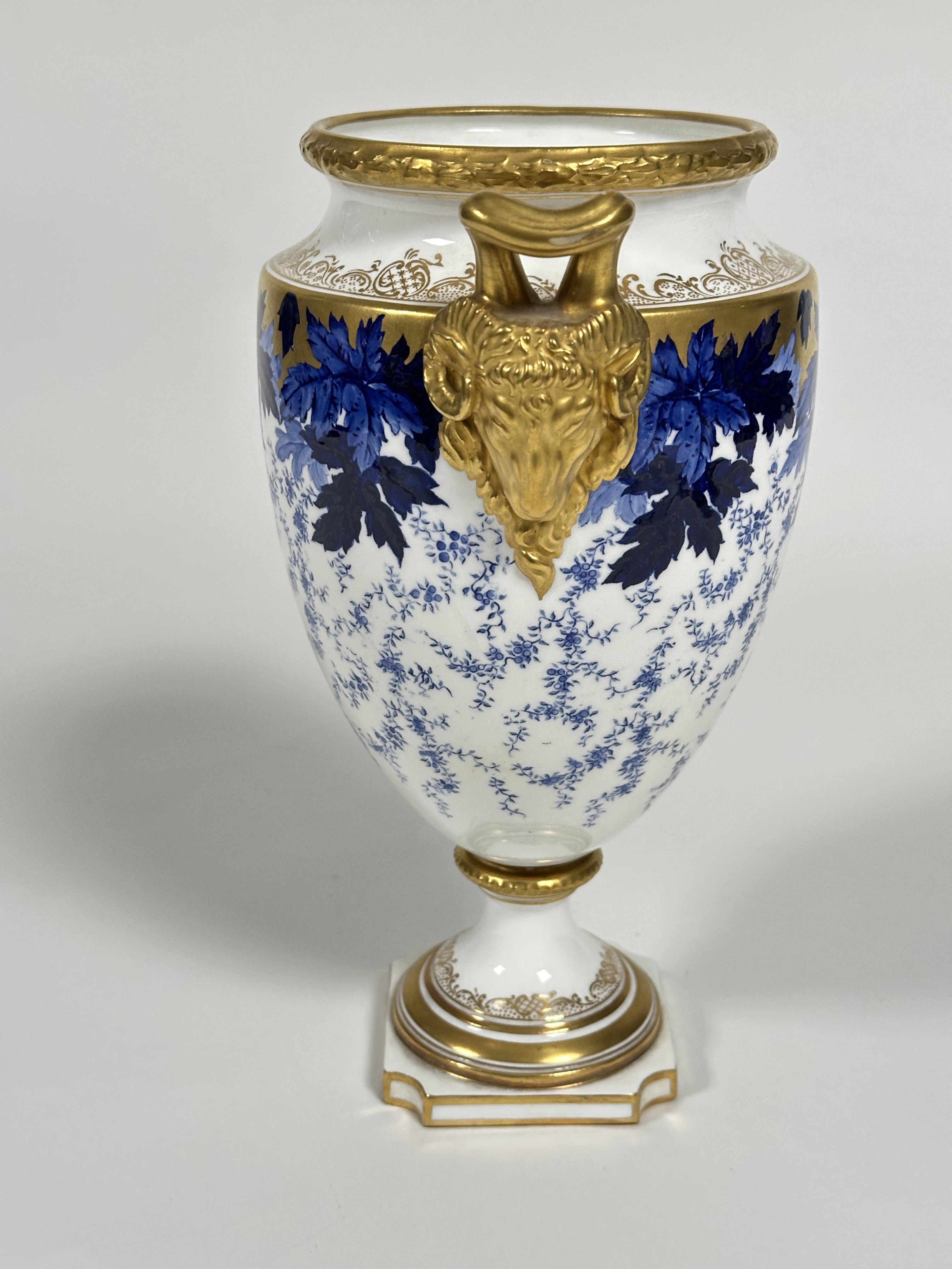 A early 20thc Coalport china two handled urn vase of tapered cylindrical form with twin gilt rams - Image 6 of 6