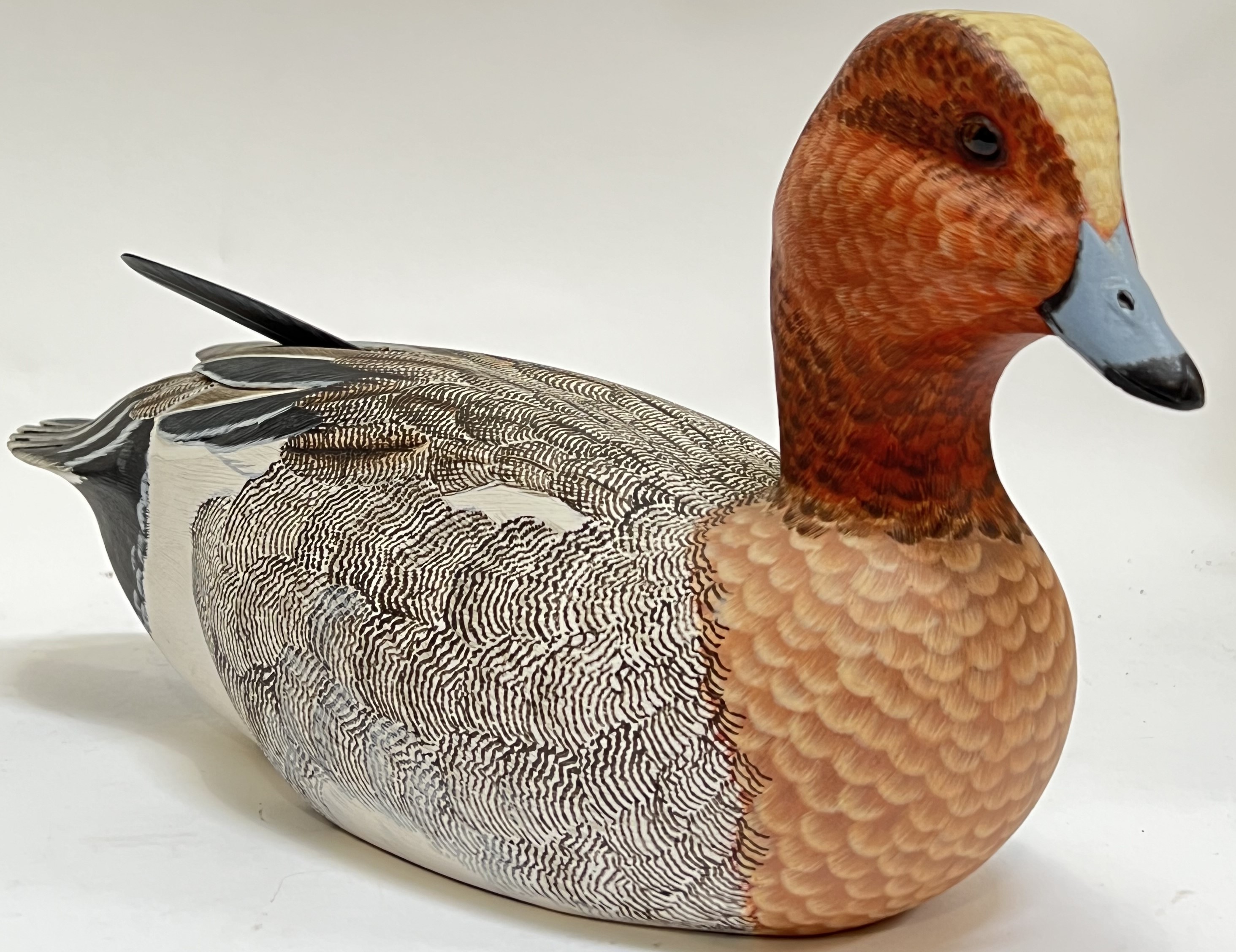 A fine quality hand-painted wooden duck decoy with glass eyes by Mike Wood (h- 18cm, w- 36cm)
