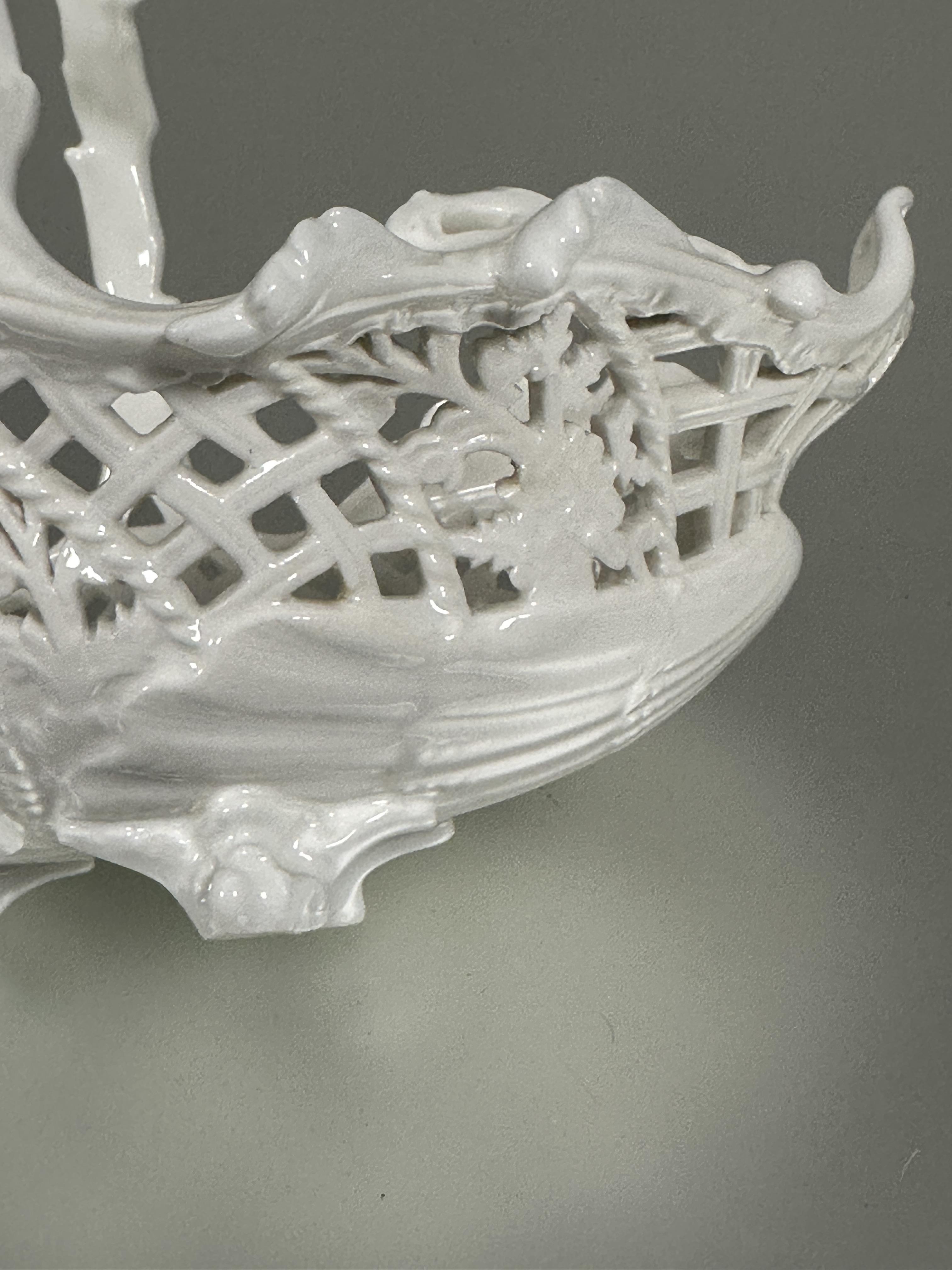 A Edwardian Coalport china blanc de chine oval pierced floral art basket with rustic handle raised - Image 6 of 8
