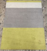 A contemporary wool rug of lineal design 230cm x 164cm.