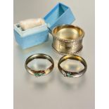 A pair of Edwardian Birmingham silver circular napkin rings mounted with enamel Scottish thistles no