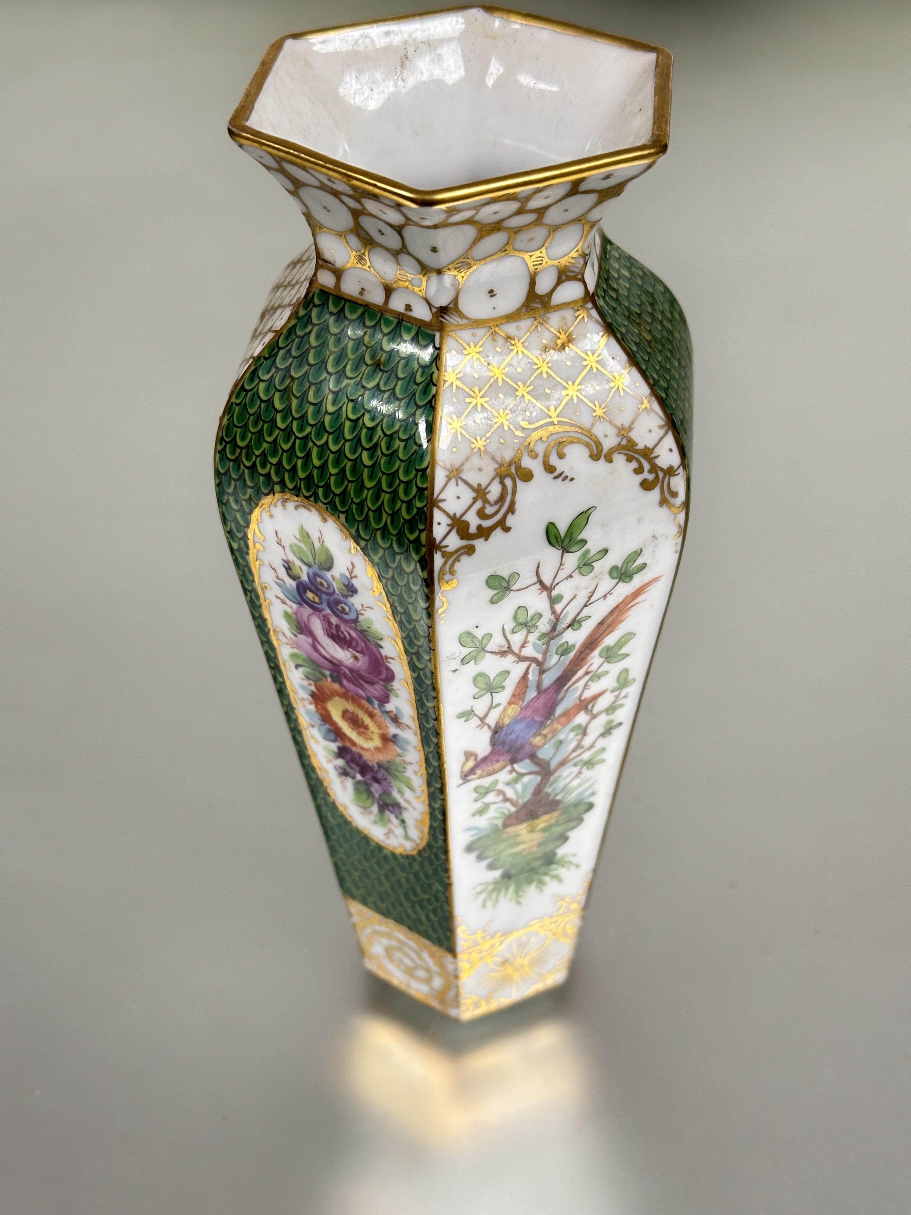 A early 20thc Dresden hexagonal tapered vase with gilt lip to top and alternation oval floral hand