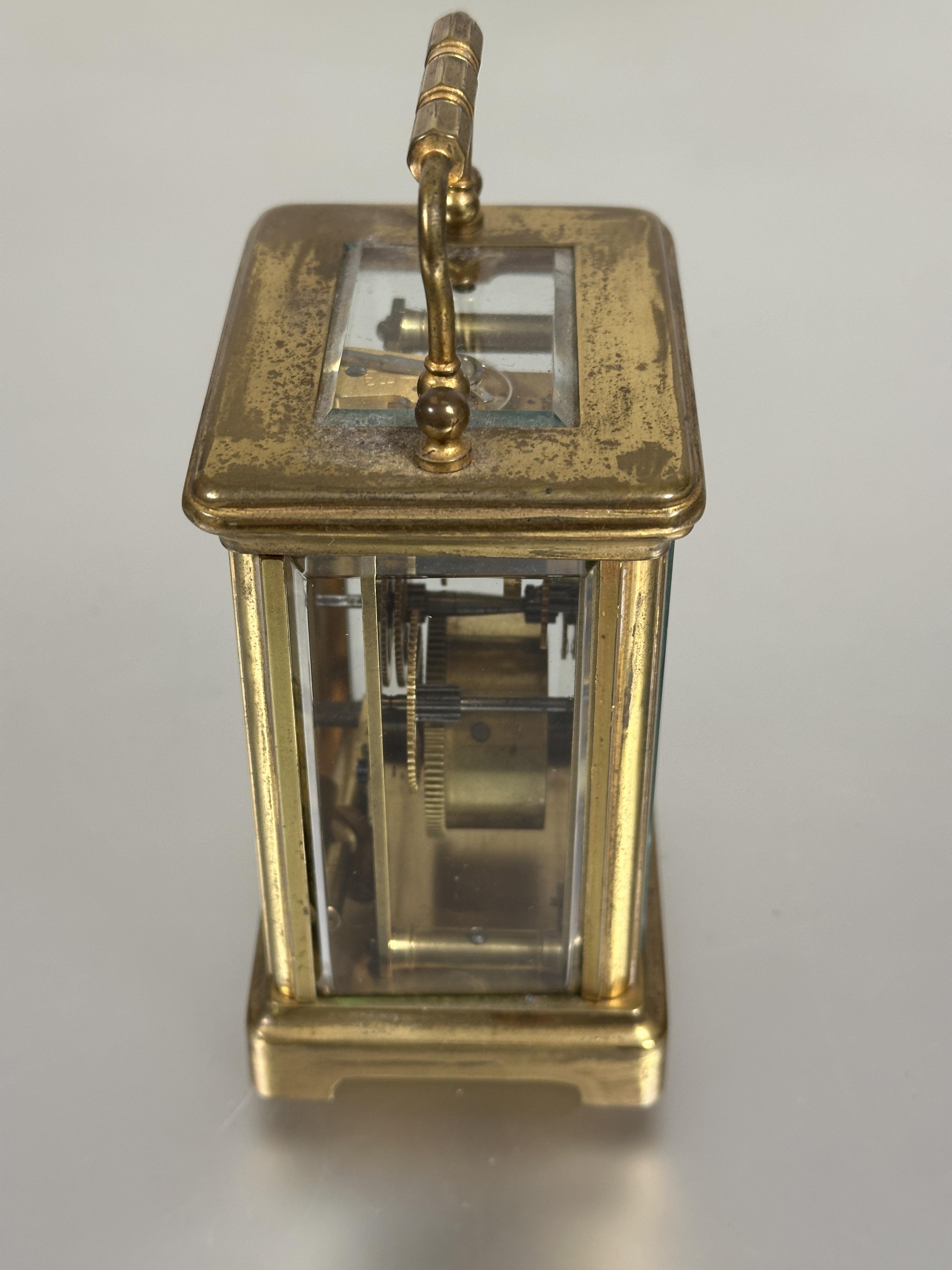 A modern brass four glass clock with folding carry handle to top white enamel dial with roman - Image 4 of 5