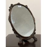 Property of the Late Countess Haig. An Edwardian walnut framed easel mirror, the frame carved with