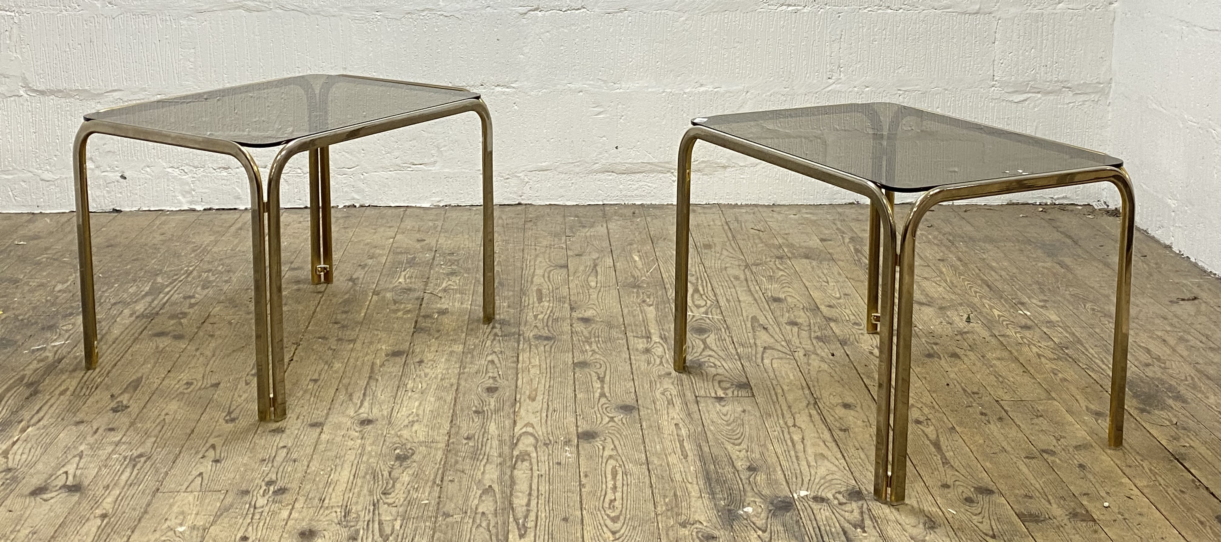A pair of Vintage 1980's gilt metal and smoked glass coffee or end tables. H52cm, 68cm x 53cm.