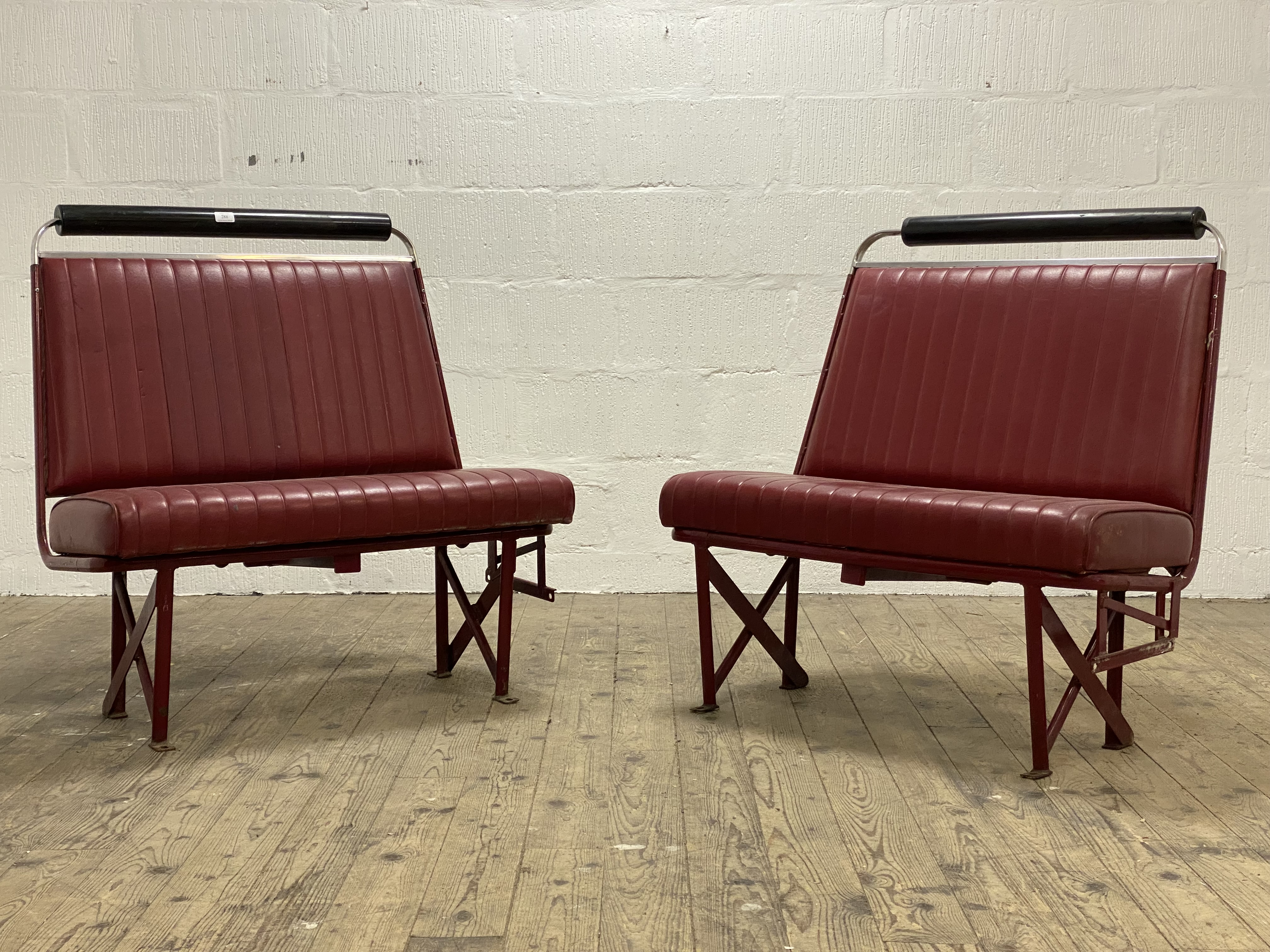 A pair of 1960's banquets / bench seats, of tubular construction and with red vinyl seat and back