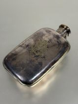 A Edwardian Epns hip flask of rounded rectangular form with screw down locking hinged cap engraved