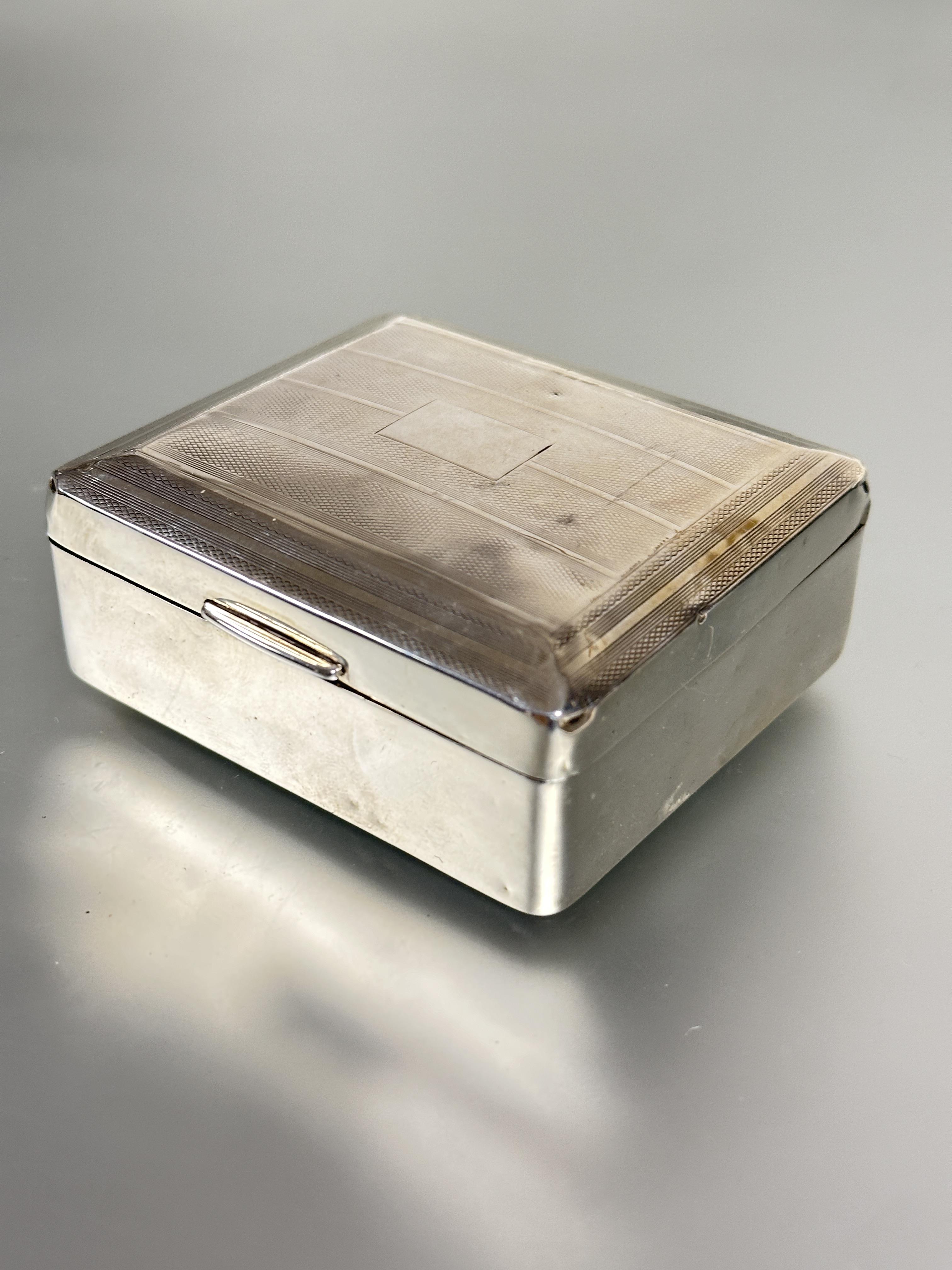 A Birmingham silver cigarette box the top with engine turned decoration enclosing a cedar lined