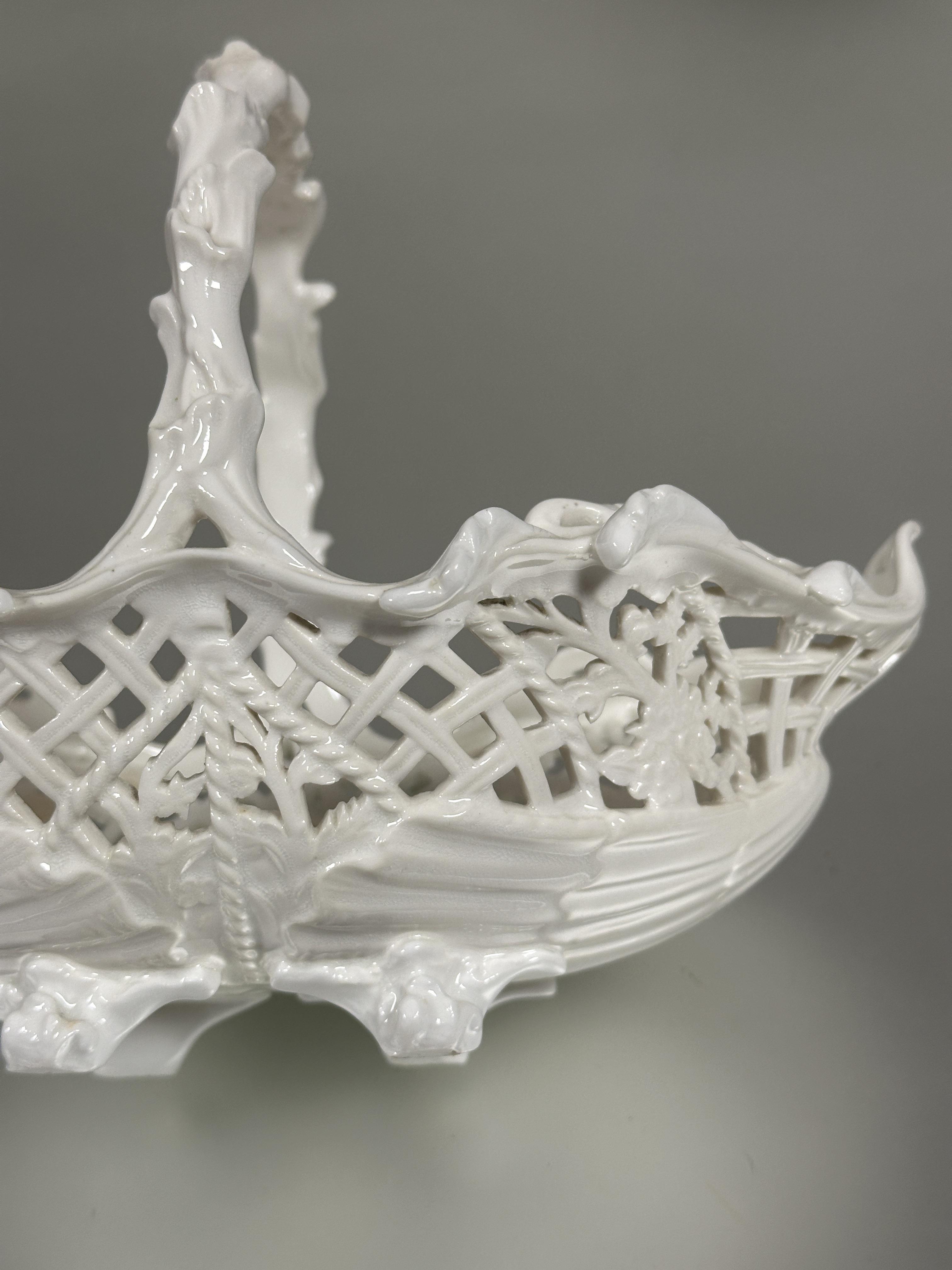 A Edwardian Coalport china blanc de chine oval pierced floral art basket with rustic handle raised - Image 8 of 8