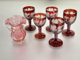 A Victorian set of five ruby to clear glass etched dessert wine glasses with vine leaf and grape