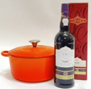 A Le Creuset style enamelled cast iron casserole pot (h- 16cm, w- 30cm), together with a 75cl bottle