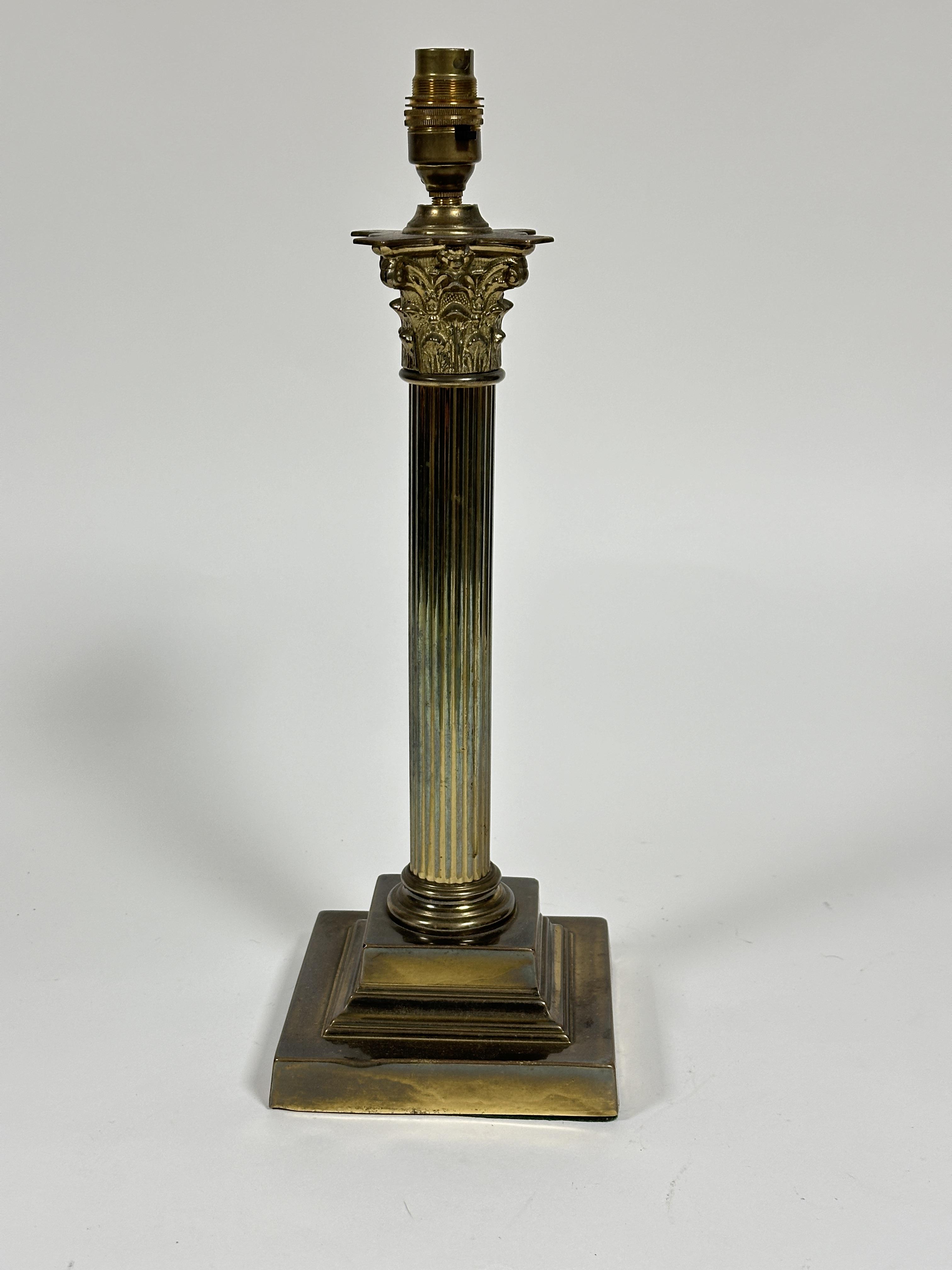 A Edwardian cast brass Corinthian fluted column oil lamp base raised on square stepped base