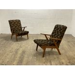 A pair of 1950s Parker Knoll oak framed open arm chairs with upholstered back and squab cushion