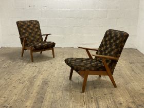 A pair of 1950s Parker Knoll oak framed open arm chairs with upholstered back and squab cushion