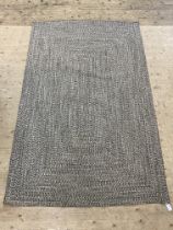 A contemporary herringbone wool rug. 245cm x 155cm.