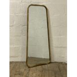 A contemporary wall hanging mirror in a plannished gilt metal frame. 57cm x 124cm.