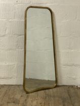 A contemporary wall hanging mirror in a plannished gilt metal frame. 57cm x 124cm.