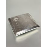 A Birmingham silver cigarette case of square curved pocket design with Art Deco engraved and