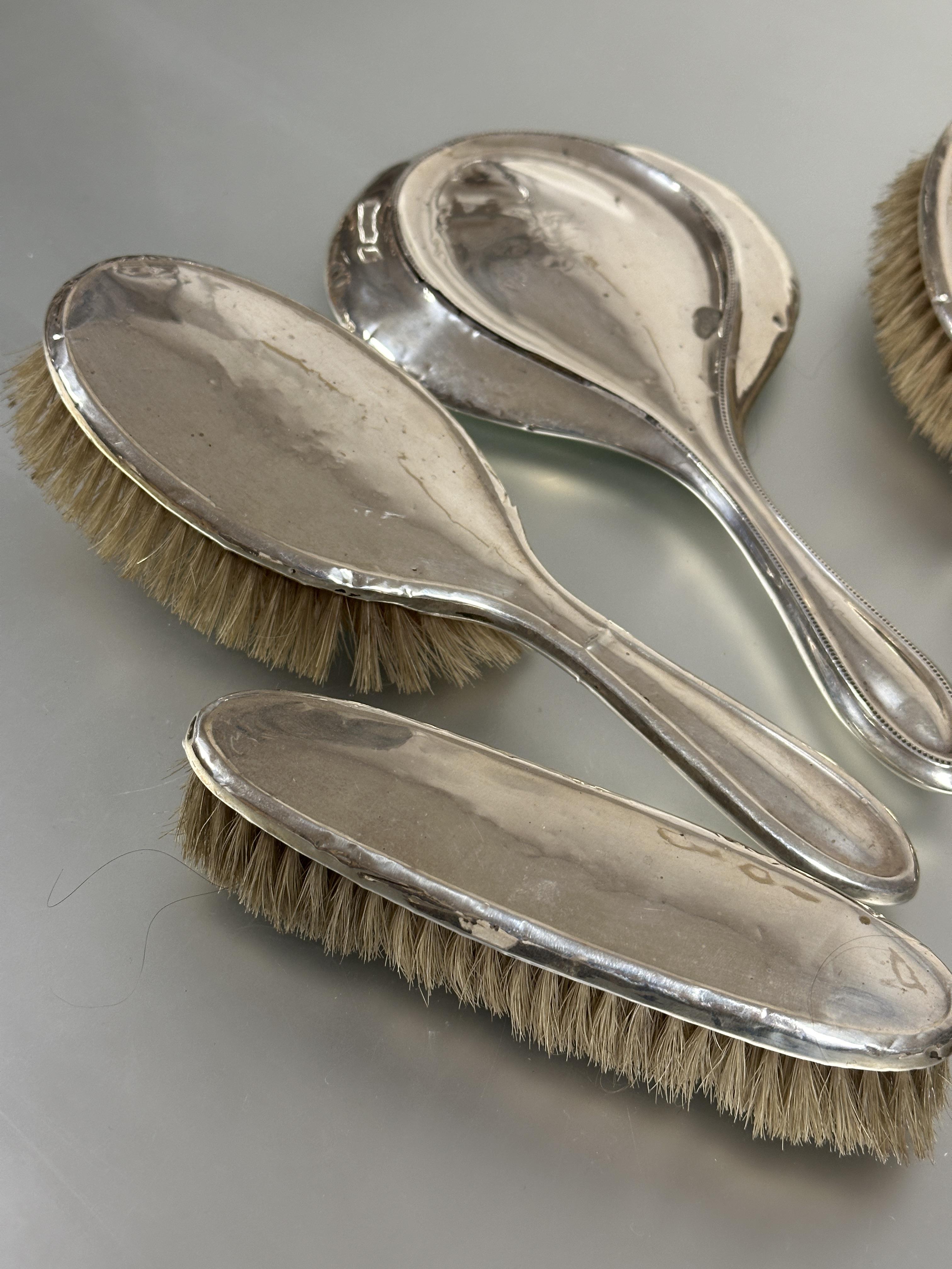 A Birmingham silver assembled dressing table set comprising a pair of oval hair brushes L x 24cm, - Image 2 of 4