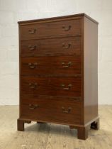 An Edwardian mahogany chest, fitted with five graduated drawers, raised on bracket supports. H116cm,