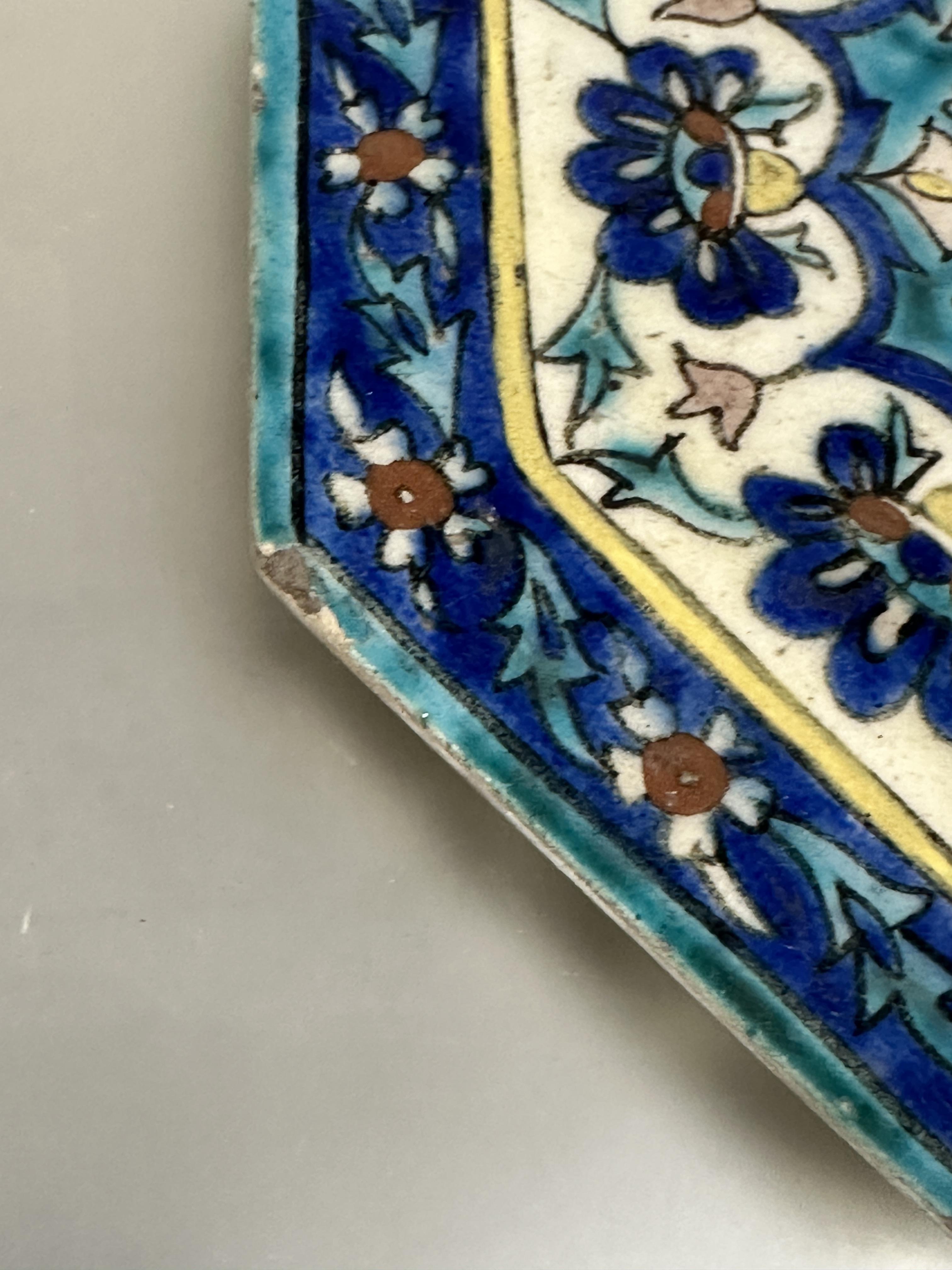 A Iznik glazed pottery octagonal tile with central flower enmclosed within a lotus leaf and flower - Image 5 of 7