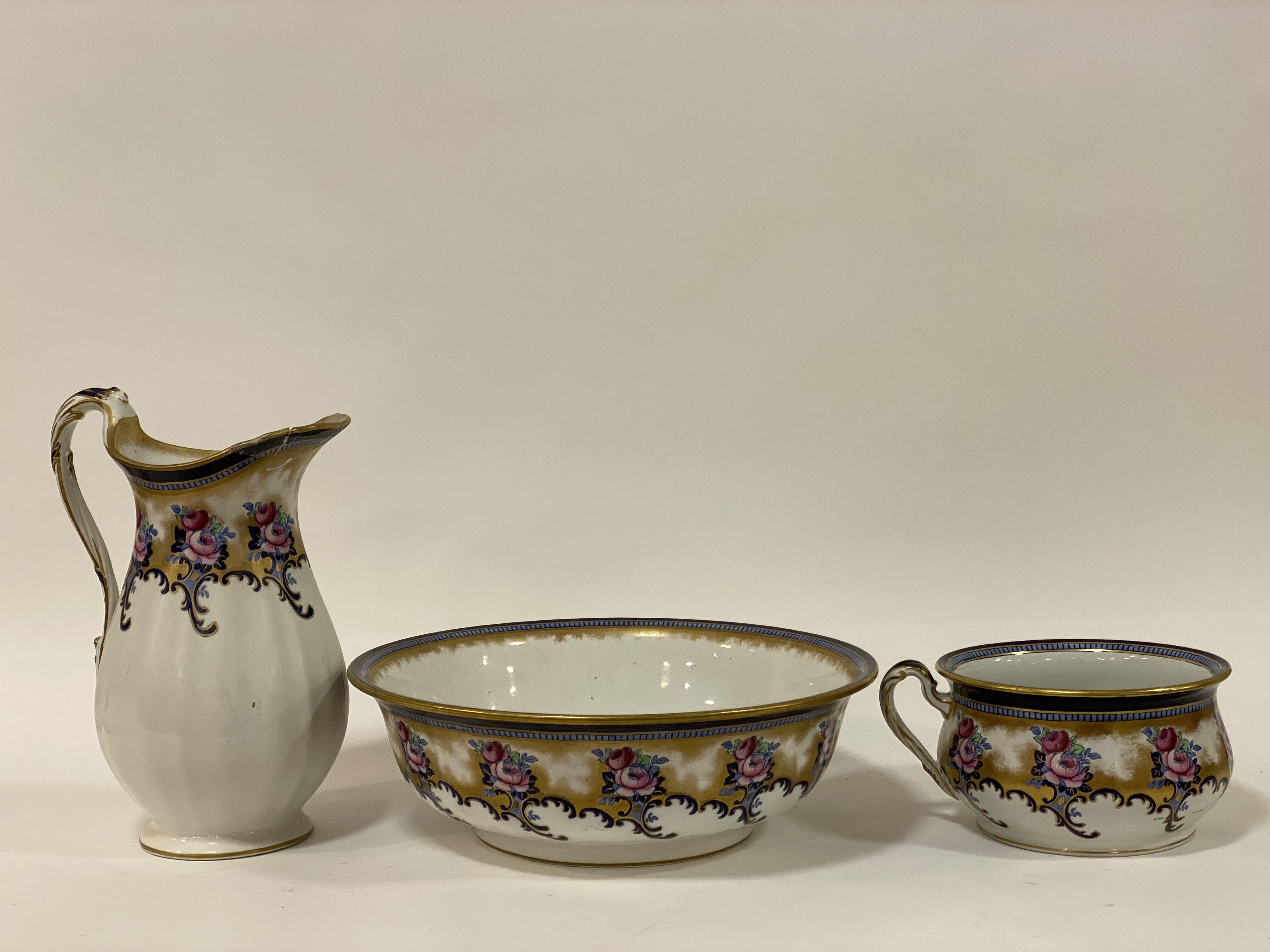 A Victorian Losol Ware three piece ceramic wash set, comprising a ewer, basin, and commode (a/f)