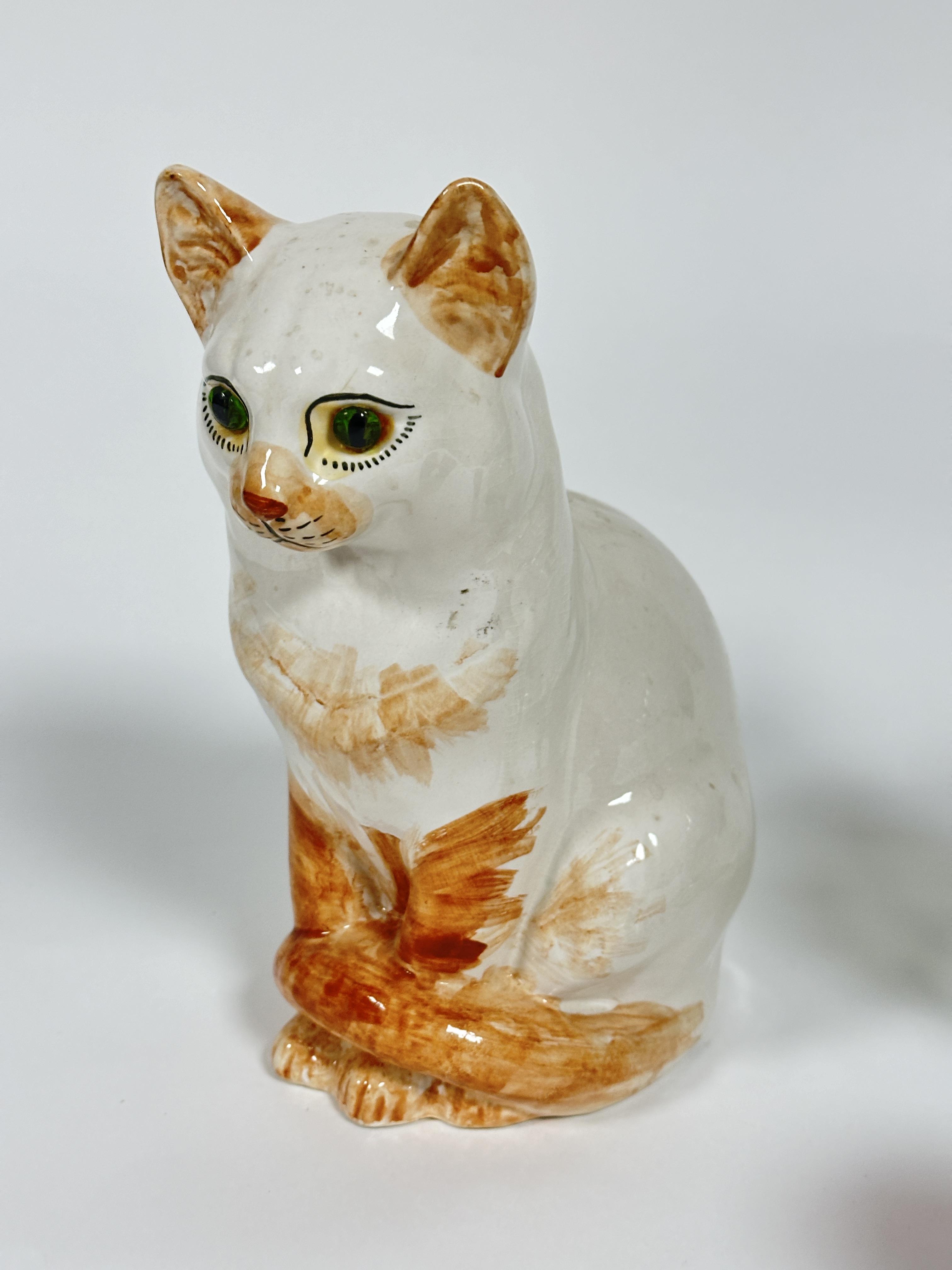A pottery ginger toirtie point seated cat figure with inset green glass eyes  H x 26cm, a ruby glass - Image 2 of 3