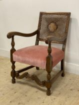 A walnut open armchair of 17th century design, circa 1930's, the back rest with bergere panel