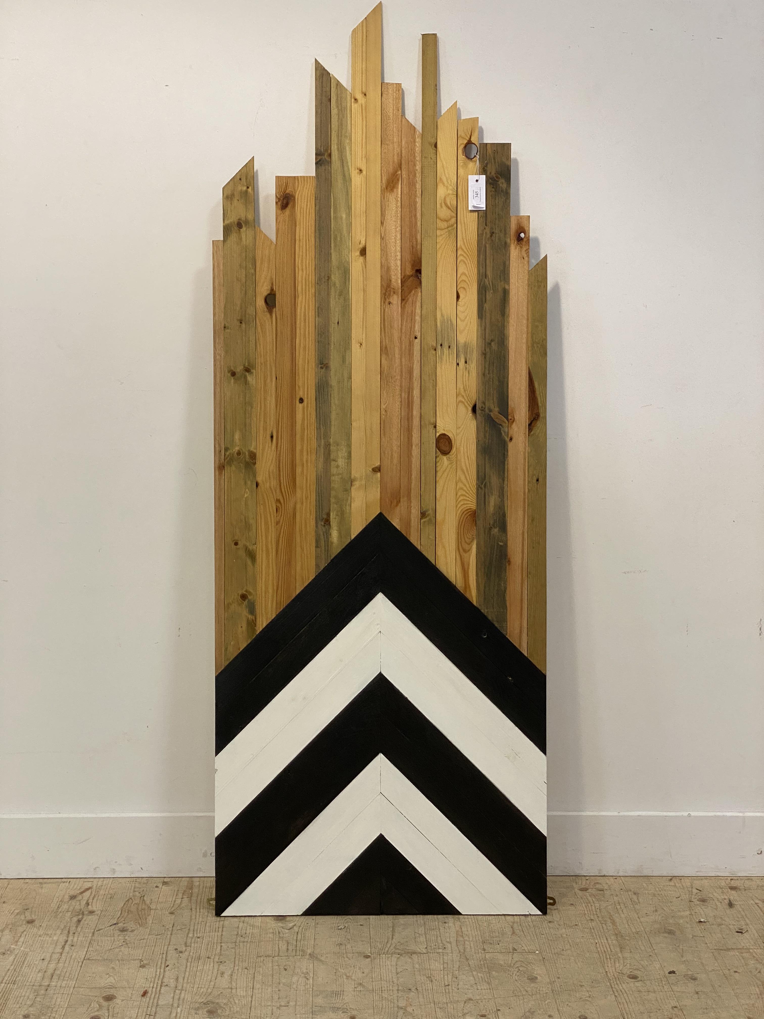 A polished pine wall hanging panel decorated with chevron design. L190cm.