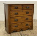 An Edwardian walnut and stained pine chest fitted with two short and three long drawers, raised on