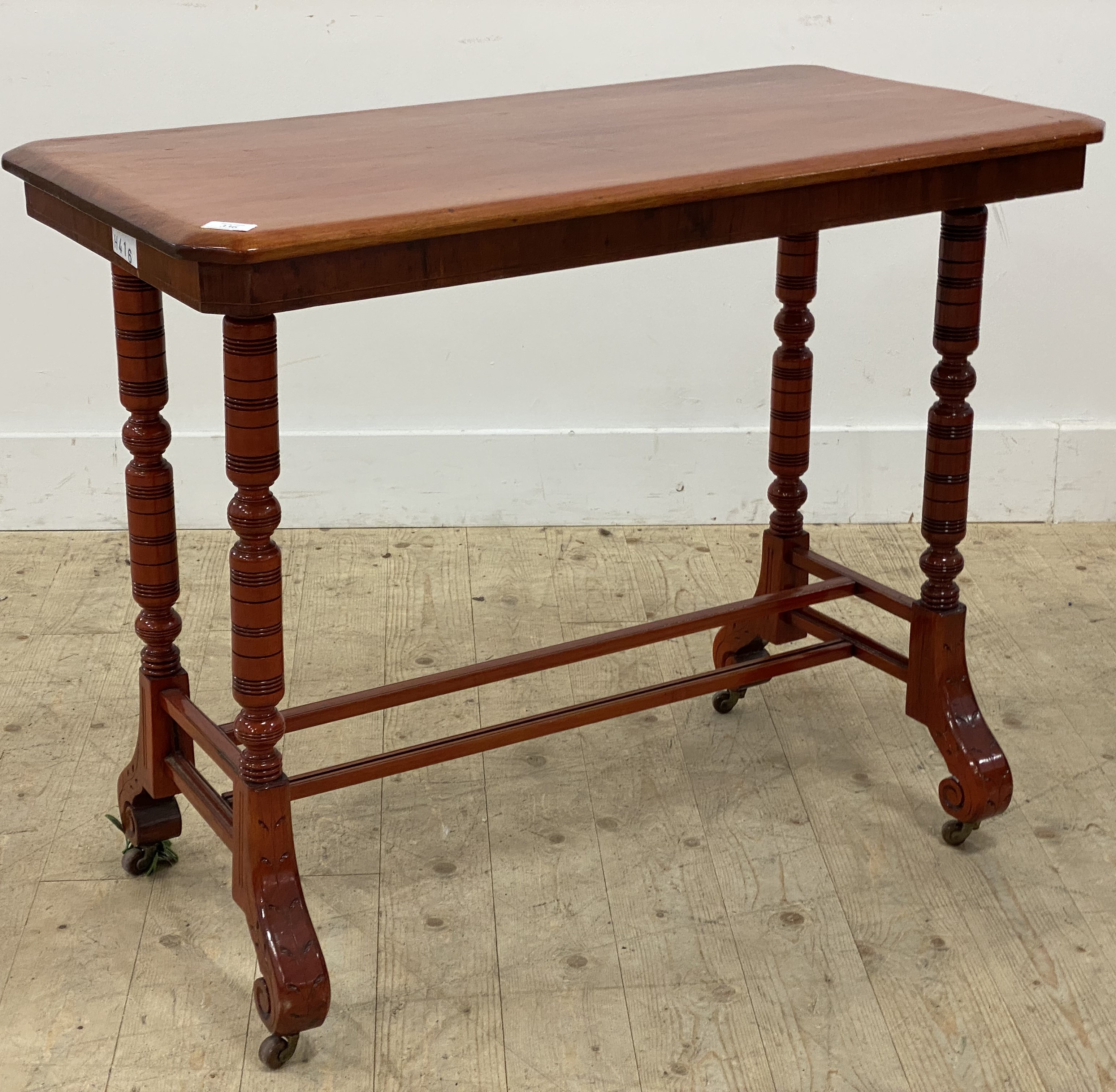 A Victorian stained mahogany stretcher table, the rectangular top raised on four turned and