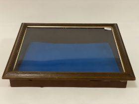 A table top display case, with sloping hinged glazed top (W57cm, H17cm, D45cm)
