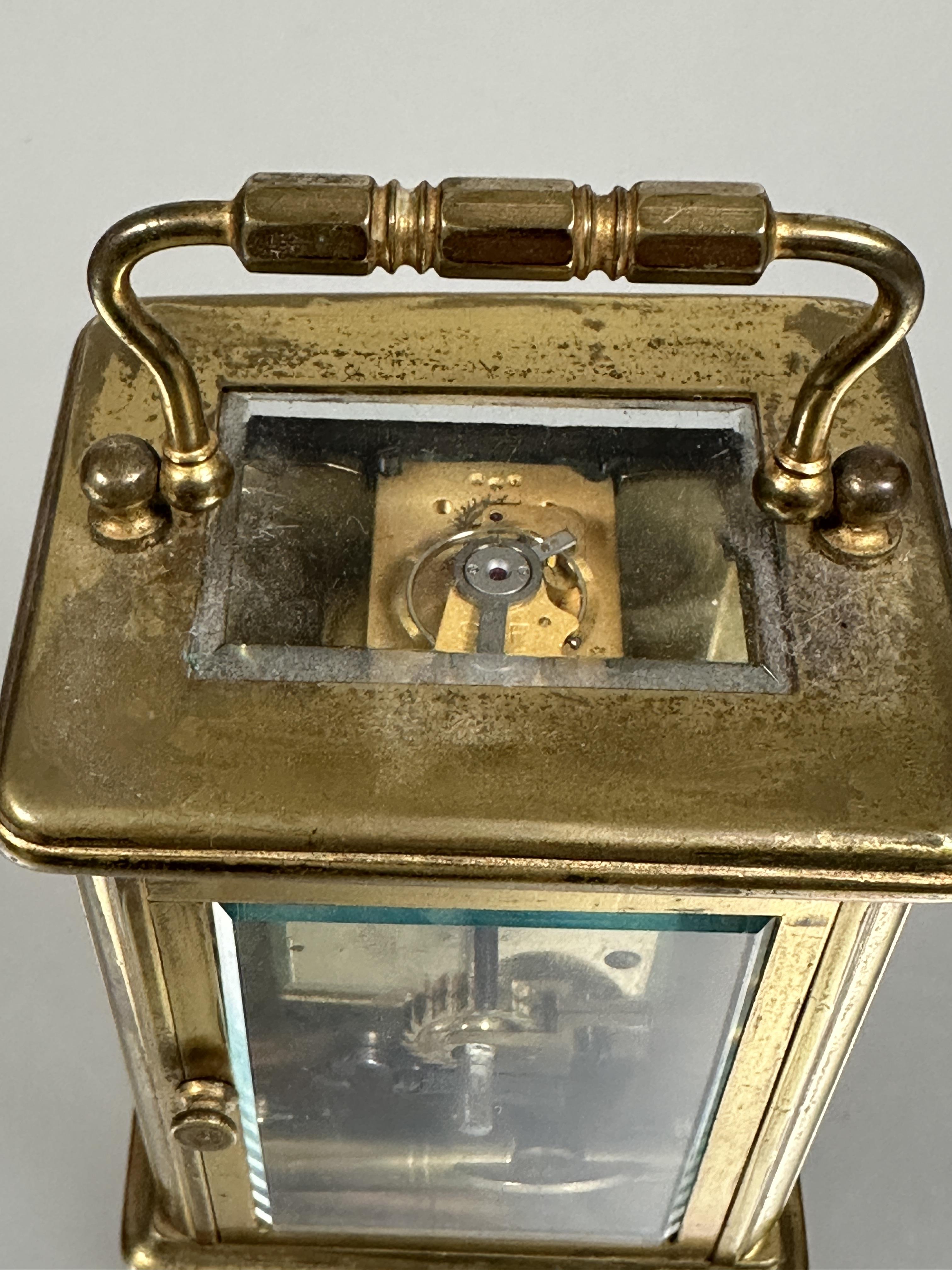 A modern brass four glass clock with folding carry handle to top white enamel dial with roman - Image 3 of 5