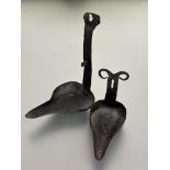 A late 18thc early 19thc cast iron crusie wall mounting pair of oil lamps with patinated finish