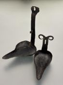 A late 18thc early 19thc cast iron crusie wall mounting pair of oil lamps with patinated finish