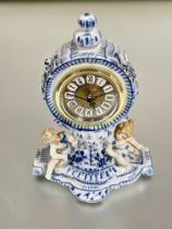 A 19thc continental drum head porcelain blue and white Meissen style mantle clock case with knop