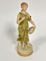 A Austrian Royal Dux figure of a maiden with tambourine in green tunic standing on circular