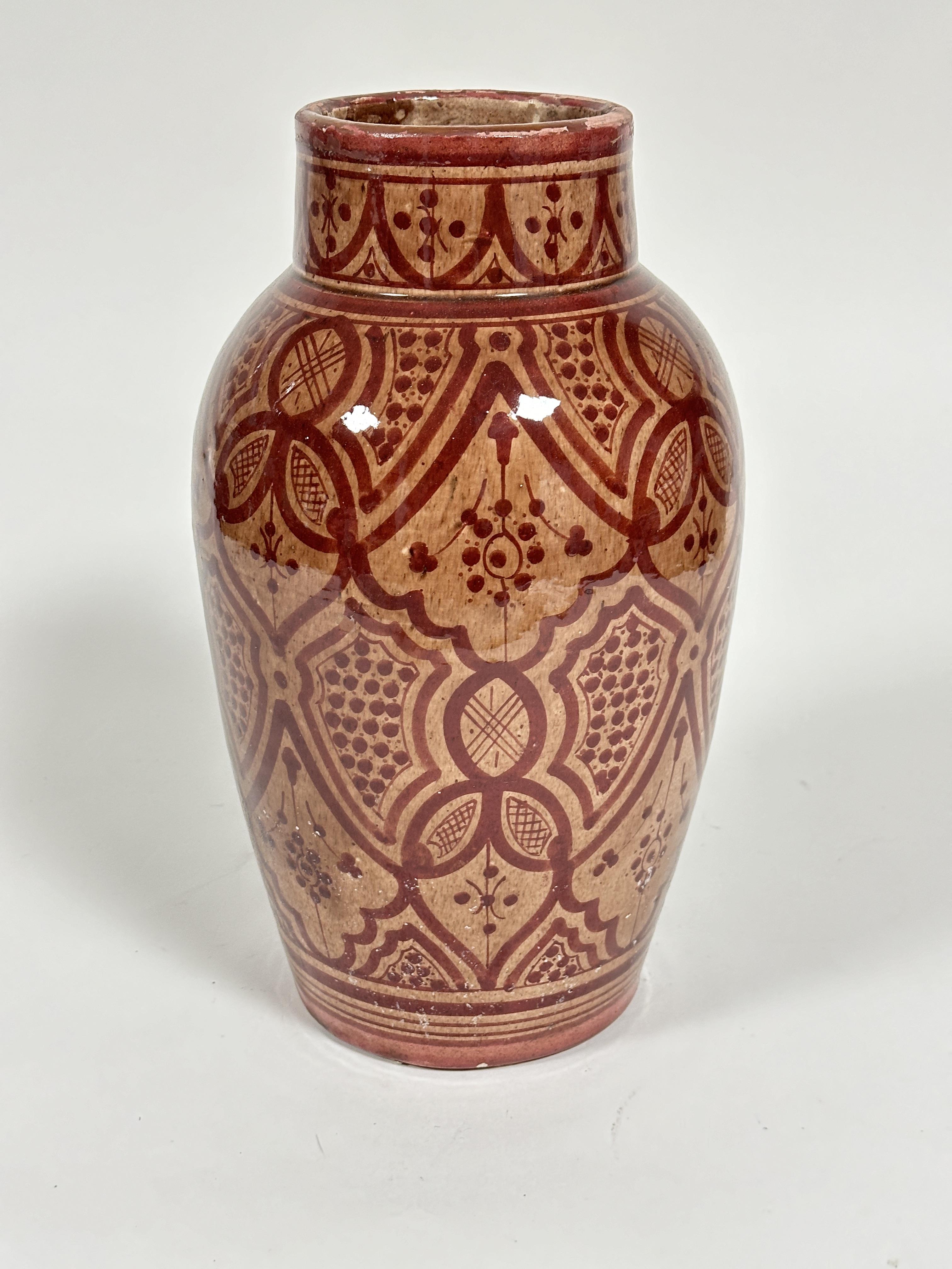 A Moroccan "Safi" red clay glazed tapered cylinder vase with stylized floral and lattice panel