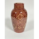 A Moroccan "Safi" red clay glazed tapered cylinder vase with stylized floral and lattice panel