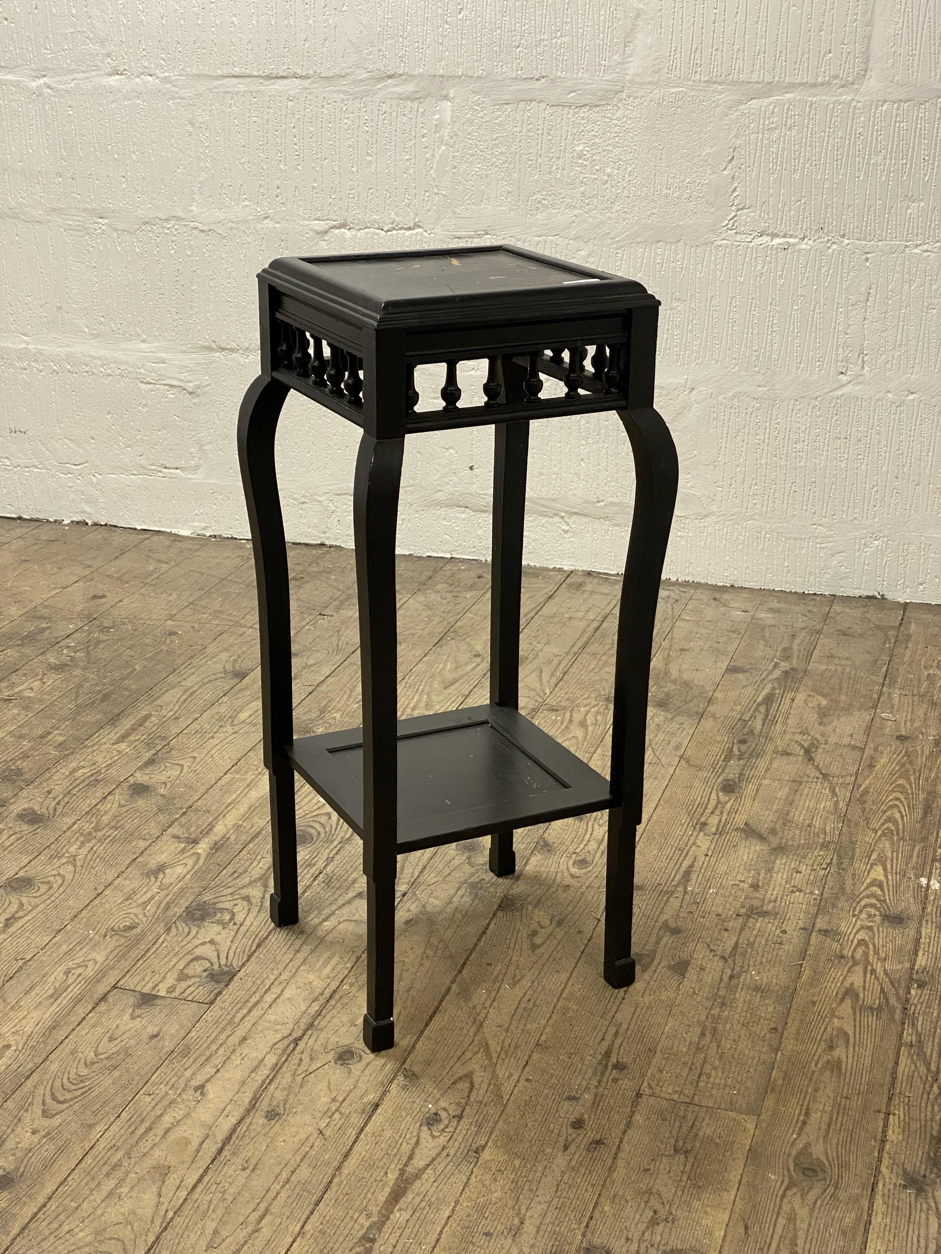 An early to mid 20th century Chinese style black painted jardiniere stand, raised on square