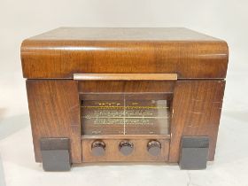 A vintage Garrard radio and record player housed in a walnut case (h- 30cm, w- 39cm)