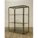A Vintage 1980's four height gilt metal and smoked glass etagere. H108cm, W88cm, D43cm.